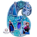 A large decorative number 6 birthday decoration featuring Frozen characters including Elsa, Anna, Sven, and Olaf, with blue glitter and snowflake details, shown against a blurred blue nighttime background. A 'Mexx_Art' logo is visible in the lower-left corner.