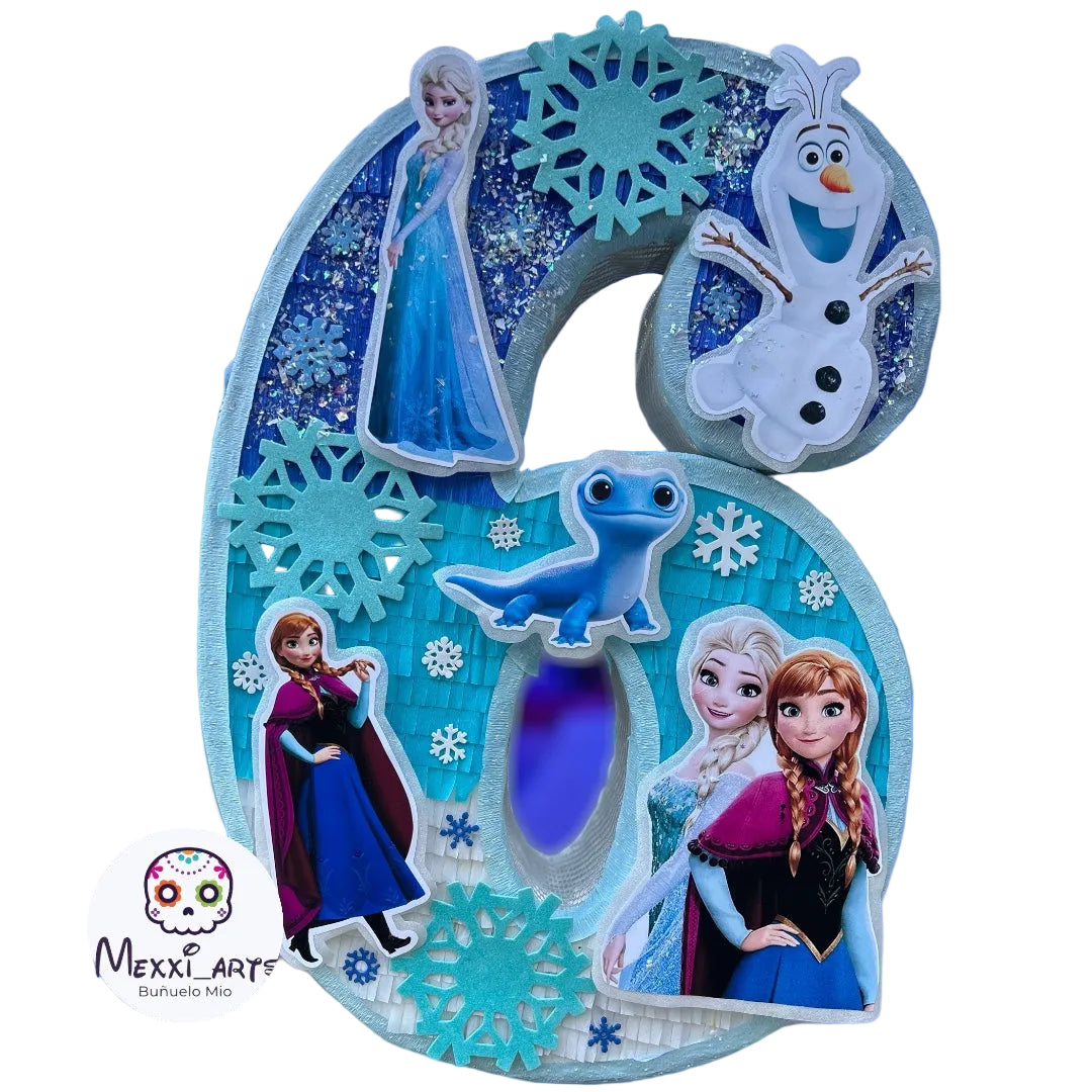 A large decorative number 6 birthday decoration featuring Frozen characters including Elsa, Anna, Sven, and Olaf, with blue glitter and snowflake details, shown against a blurred blue nighttime background. A 'Mexx_Art' logo is visible in the lower-left corner.